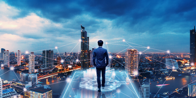 A Man in a Suit Looks Over a Futuristic Cityscape Illustrating How Web 3.0 Connects Data, Devices and More.
