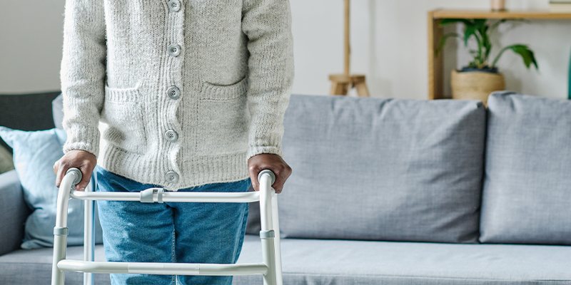 HME Walker Being Used for Stability Standing in a Living Room