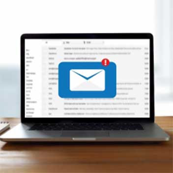 Laptop on a desk with an inbox notification on the screen