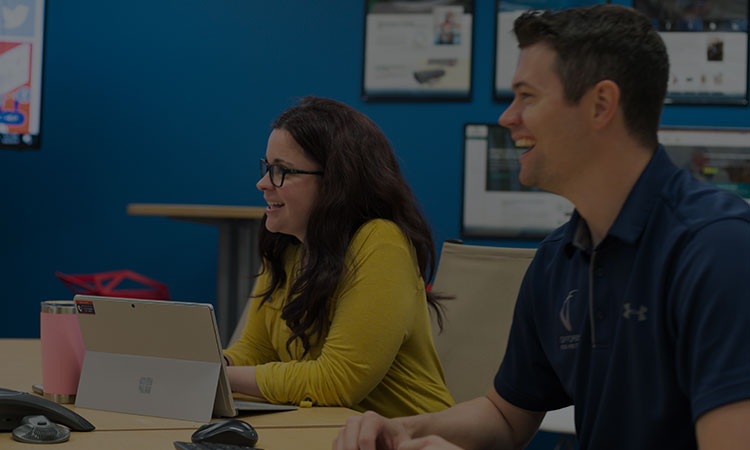 Two Forbin employees looking to the side while smiling