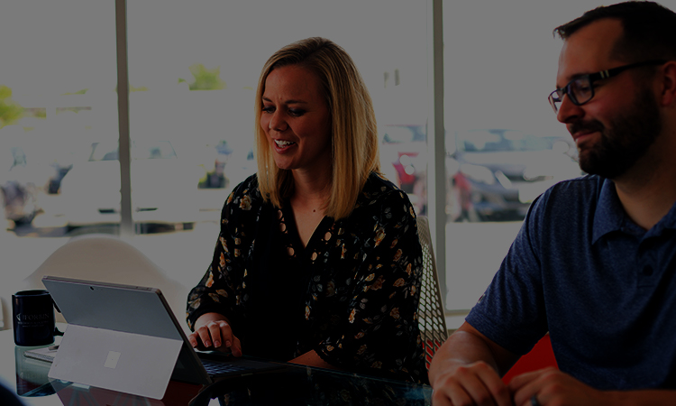 Two Forbin employees looking to the side while smiling