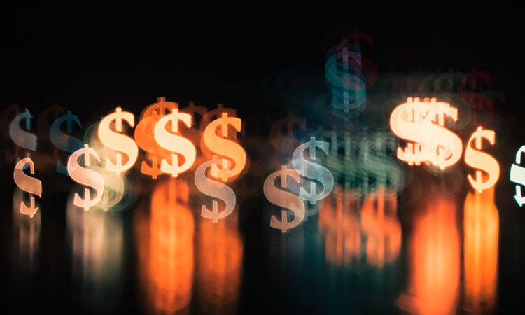 black background with blurry colorful dollar signs in the foreground