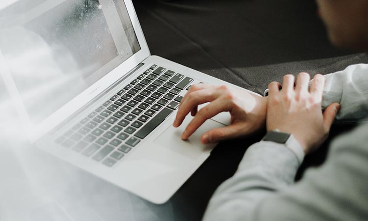 over the shoulder view of person using a laptop computer
