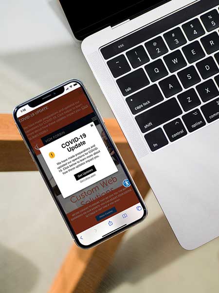 iPhone viewing web page with COVID-19 notification popup