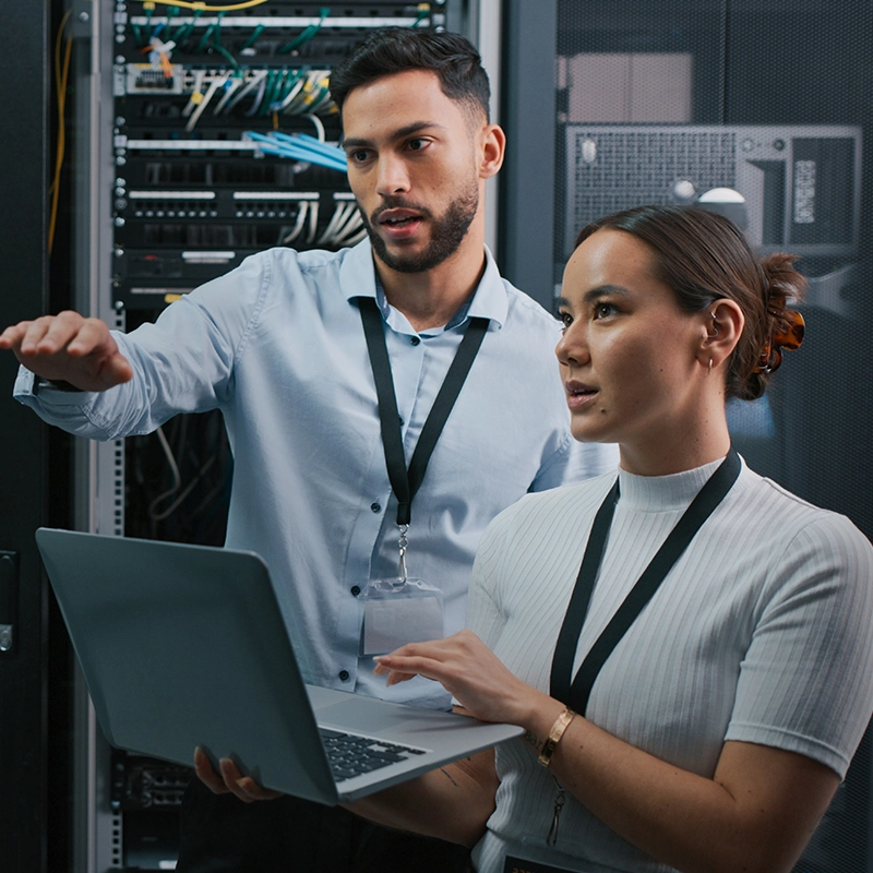 two technicians working together to fix a server 