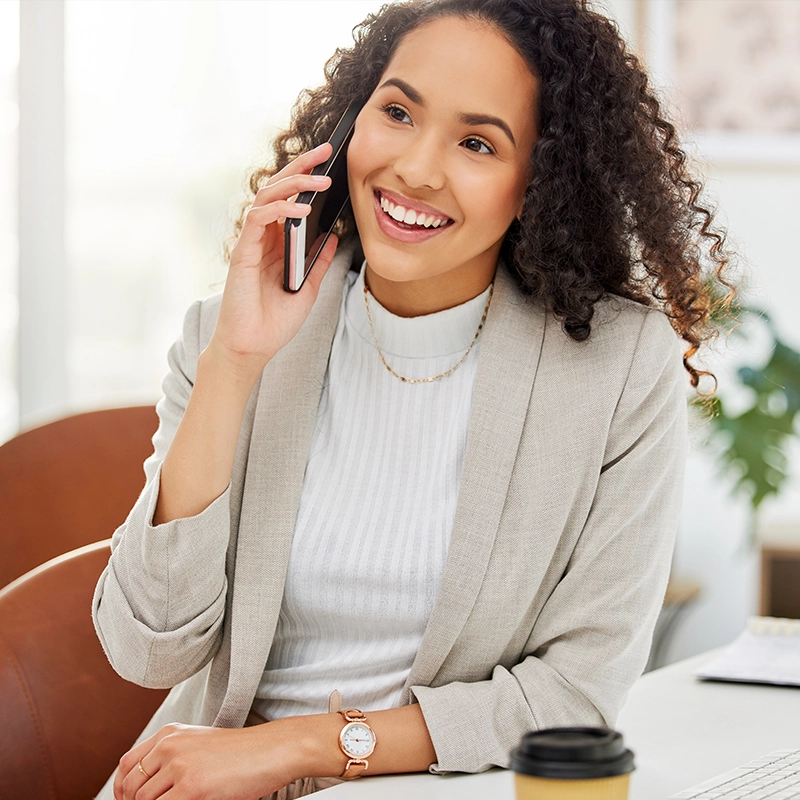 image of young woman smiling while talking on the phone