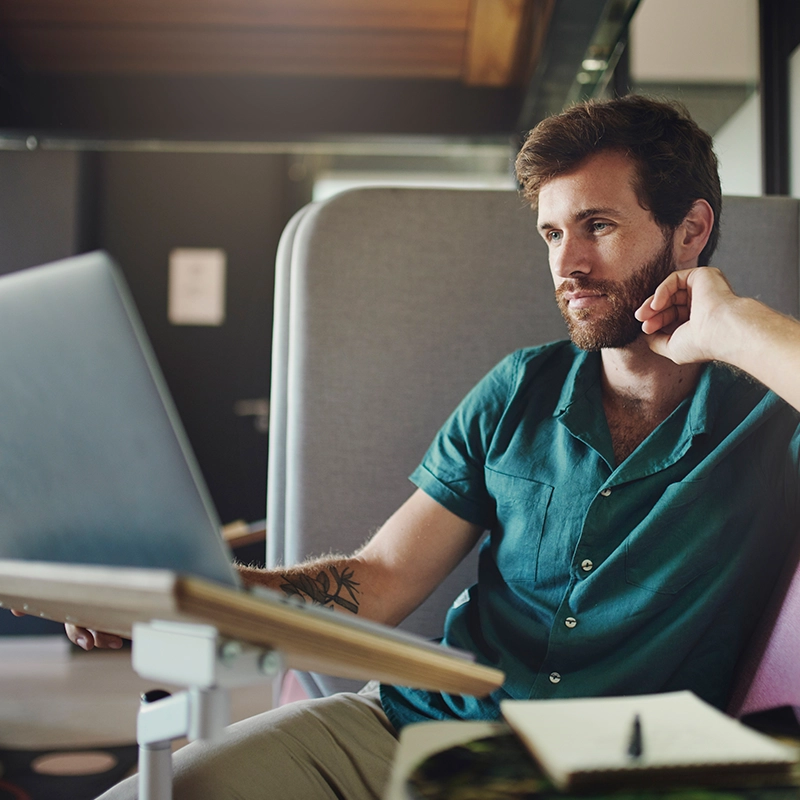 image of young male using laptop computer in office